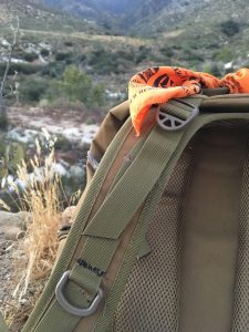 A survival bandana in blaze orange tied to my pack