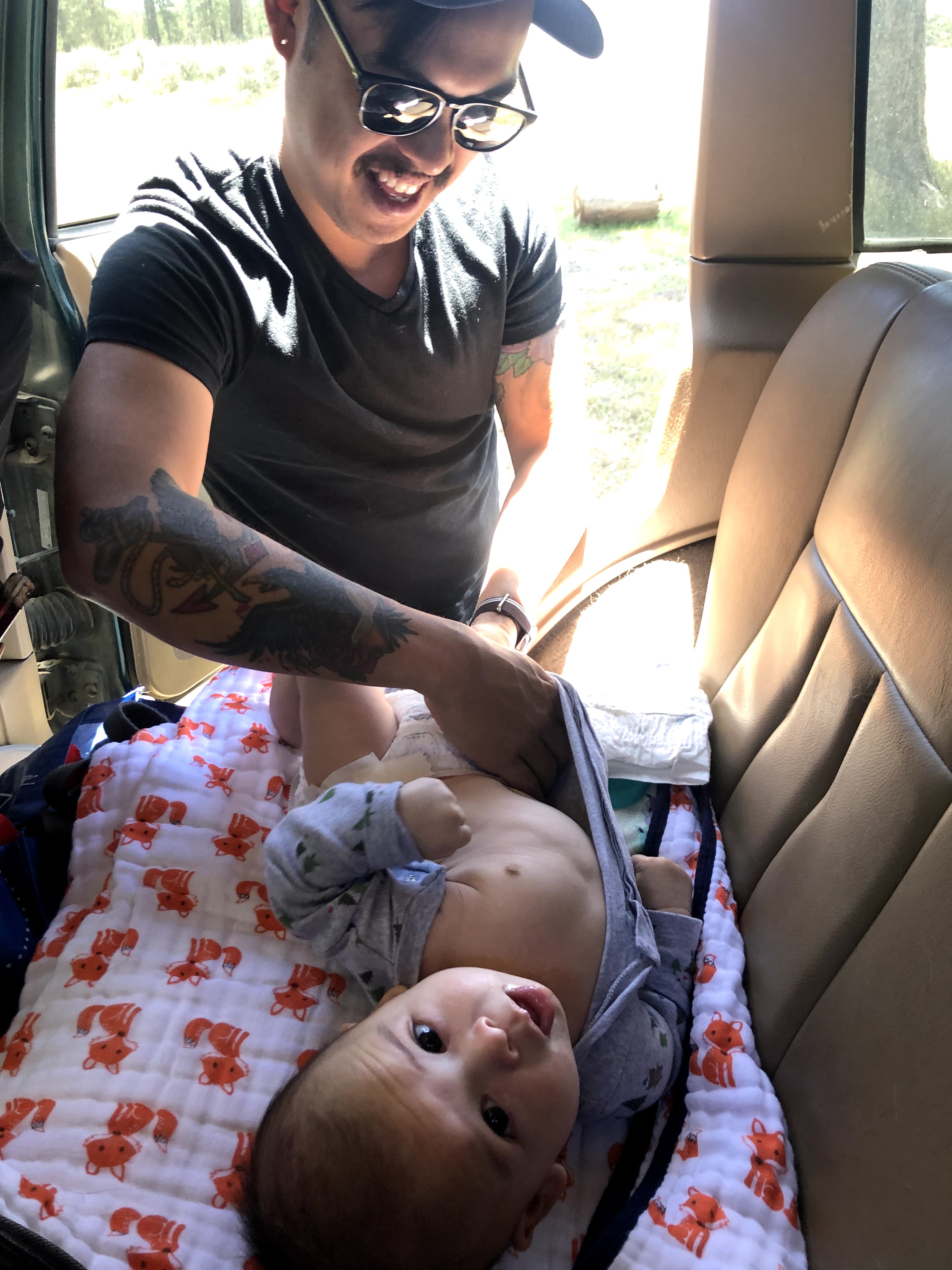 changing baby while car camping