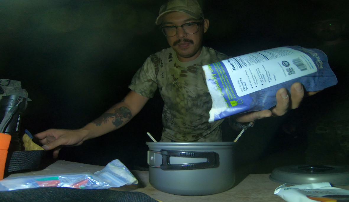 adding dehydrated meals to camp cookware to hydrate